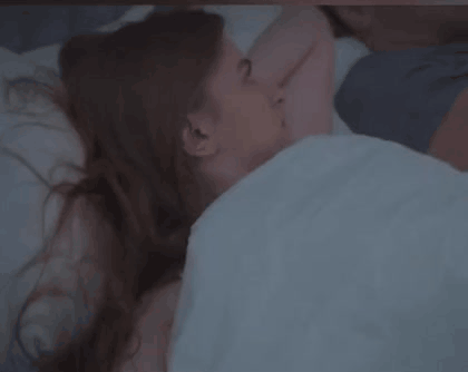 Couple in bed: one partner awake and frustrated, the other snoring